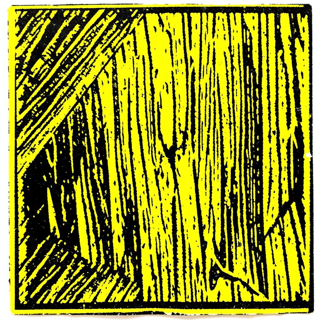 A carved linocut relief print of a vintage shop interior with shelves of pottery and glassware, in muted mustard yellow, slate blue, and warm gray.